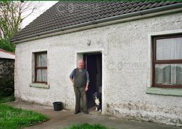 Irish photography. The Galway Gallery. Michael & the dog at home in Kinvara - Co. Galway